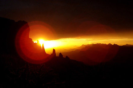 The sun sets through the 'praying hands' of the Superstition Mountains